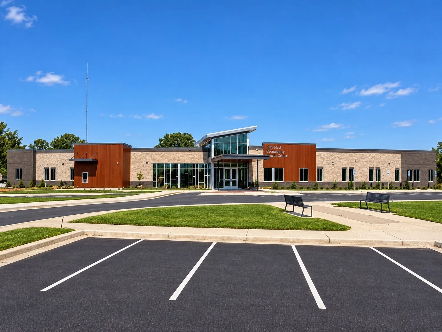Olly Neal Community Health Clinic exterior, landscaped grounds, and parking area
